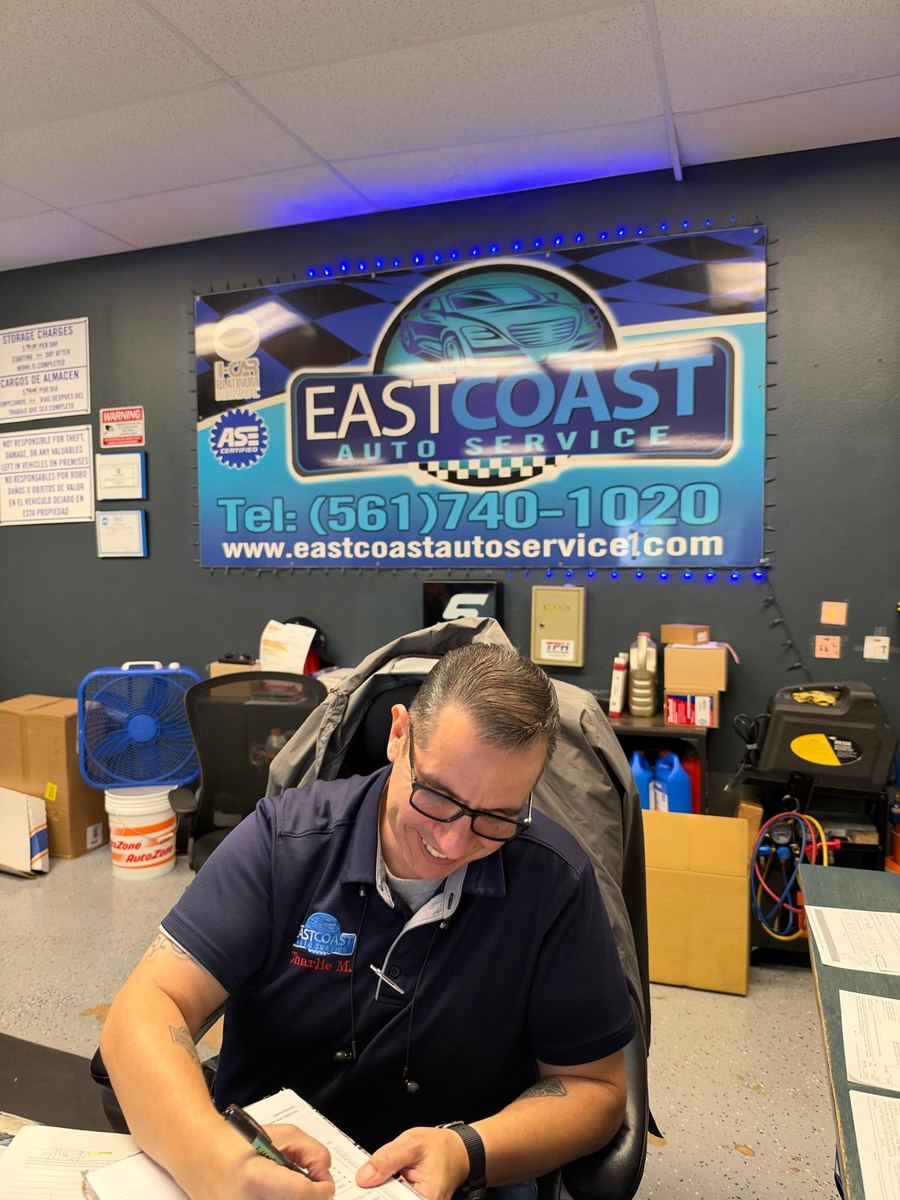 Service advisor preparing a vehicle inspection report at East Coast Auto Service